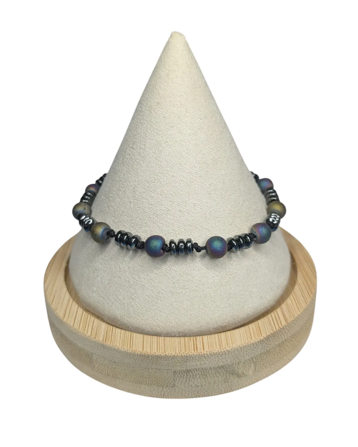 Druzy agate and hematite bracelet displayed on a cream bracelet stand with a wood base.