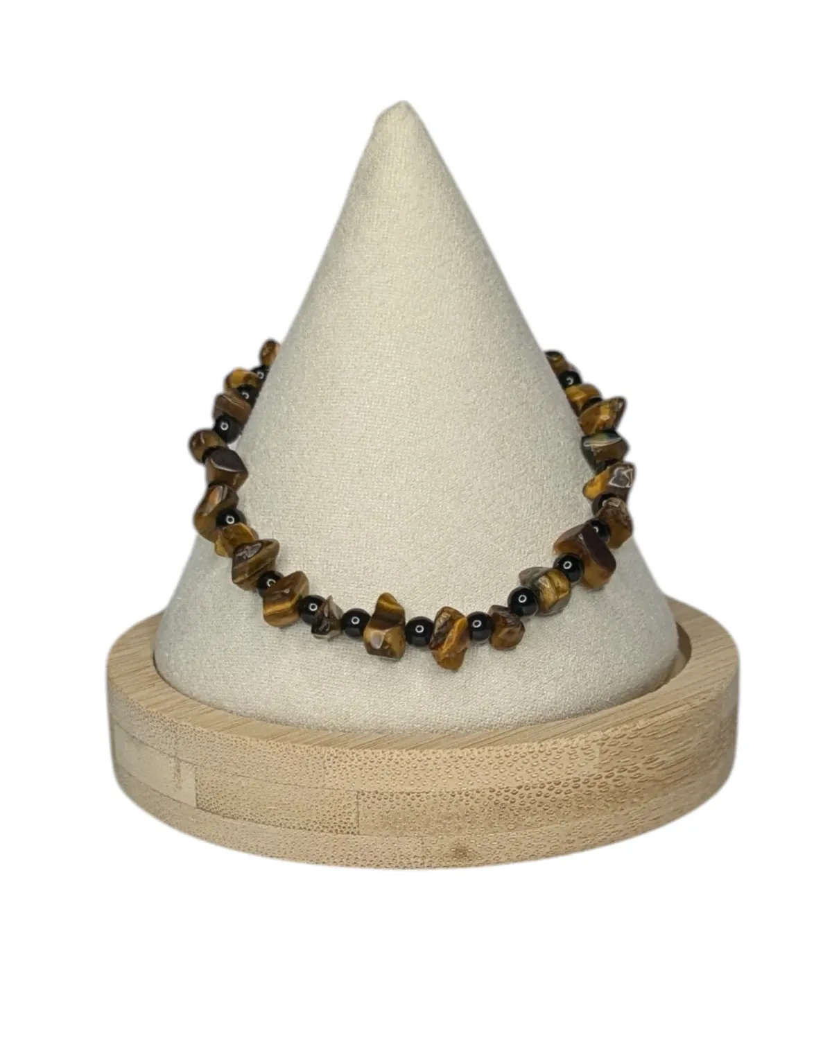 Tiger's-eye chip and polished black obsidian bracelet displayed on a cream bracelet stand with a wood base.